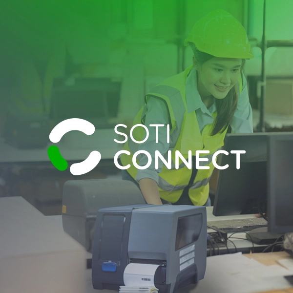 SOTI Connect | Warehouse worker using a computer and printer